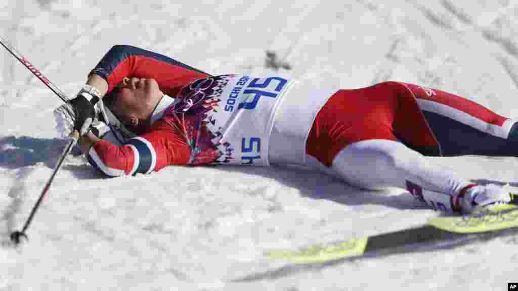 Norway's Marit Bjoergen catches her breath after the women's 10K classical-style cross-country race at the 2014 Winter Olympics, Feb. 13, 2014.