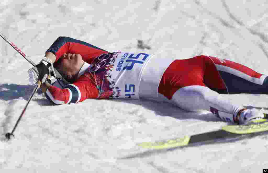 Norway's Marit Bjoergen catches her breath after the women's 10K classical-style cross-country race at the 2014 Winter Olympics, Feb. 13, 2014.