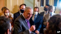 FILE - Senate Majority Leader Chuck Schumer, D-N.Y., speaks to reporters as work continues on the Democrats' Build Back Better Act, massive legislation that is a cornerstone of President Joe Biden's domestic agenda, at the Capitol, in Washington, Sept. 14