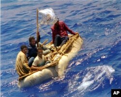 FILE - Cuban refugees float in heavy seas 60 miles south of Key West, Florida, Aug. 26, 1994.