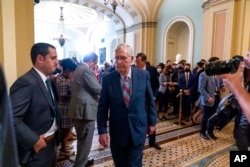 FILE - Senate Minority Leader Mitch McConnell, R-Ky., walks away after speaking with reporters as work continues on the Democrats' Build Back Better Act, massive legislation that is a cornerstone of President Joe Biden's domestic agenda, at the Capitol, i