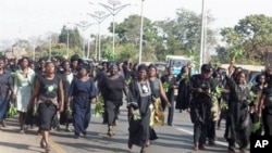 Hundreds of women march through the streets to protest the killing of women and children and destruction of properties in Jos, Plateau State in central Nigeria on January 31, 2011