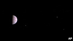 This July 10, 2016, image released by NASA was taken by the Juno spacecraft, five days after it arrived at Jupiter. The image shows Jupiter's Great Red Spot and three of its four largest moons. (Juno/NASA/JPL-Caltech/SwRI/MSSS via AP)