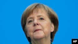 German Chancellor Angela Merkel, Chairwoman of the Christian Democratic Union, CDU, smiles during a press statement at the headquarters of the Christian Democratic Union in Berlin, Germany, Feb. 7, 2018.
