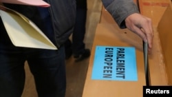 A man casts his vote in the European Parliament Elections, during the Belgian general and regional elections and European Parliament elections, in Limal, Belgium, May 26, 2019.