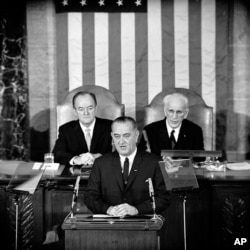 In this March 15, 1965 file photo, President Lyndon B. Johnson addresses a joint session of Congress in Washington where he urged the passing of the Voting Rights Act.