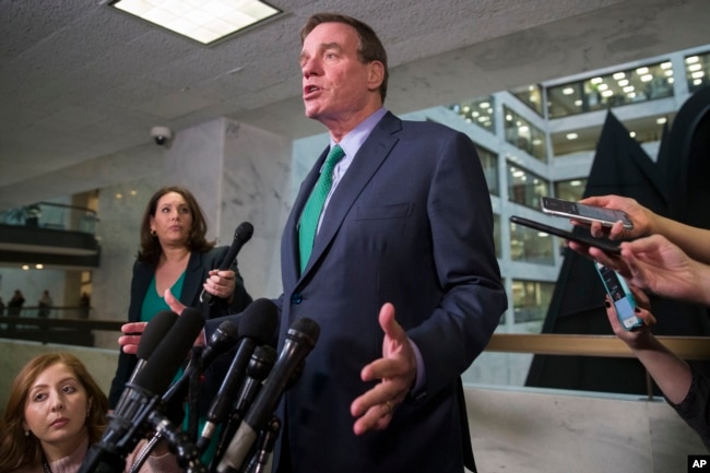 FILE - Sen. Mark Warner, D-Va., speaks after hearing some of the testimony from Michael Cohen, President Donald Trump's former lawyer, before a closed door hearing of the Senate Intelligence Committee on Capitol Hill, Feb. 26, 2019, in Washington.