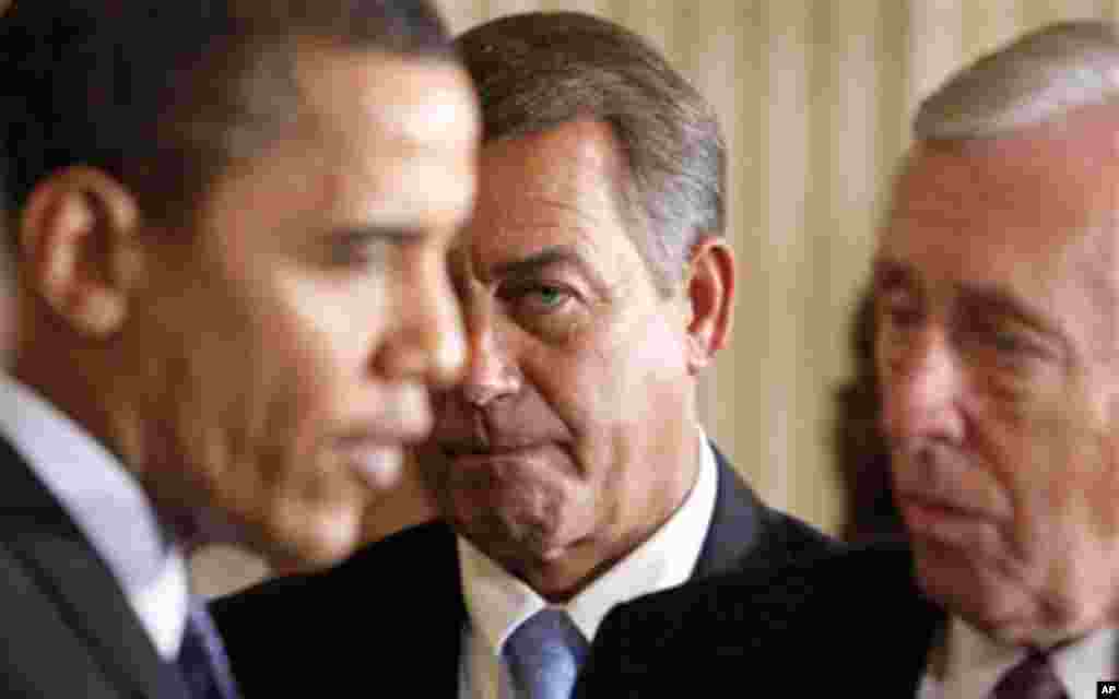 In this Feb. 23, 2009, file photo House Minority Leader John Boehner of Ohio, center, looks on as President Barack Obama, left, talks to House Majority Leader Steny Hoyer of Md., following the president's address to lawmakers at the start of the Fiscal Re