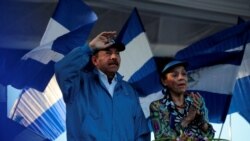 FILE - Nicaraguan President Daniel Ortega and Vice President Rosario Murillo gesture during a march called 'We walk for peace and life. Justice' in Managua, Nicaragua, Sept. 5, 2018.