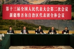 2019年3月12日在北京人民大会堂举行的全国人大会议新疆维吾尔自治区代表团会议上，新疆党委书记陈全国（中）讲话。