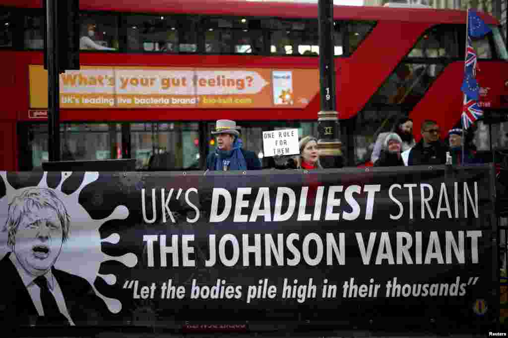 People gather to protest against the Conservative Party in London, Britain, Jan. 12, 2022.