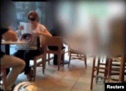Russian spy Anna Chapman and an undercover agent meet in a coffee shop in New York in this still image taken from June 26, 2010 footage.