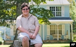 FILE - Transgender high school student Gavin Grimm poses in front of his home in Gloucester, Virginia, Aug. 22, 2016.