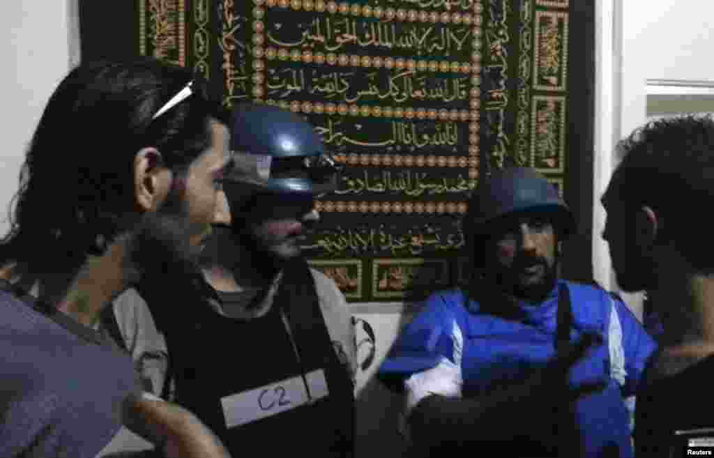 U.N. chemical weapons experts meet residents at one of the sites of an alleged poison gas attack in a southwestern Damascus suburb, August 26, 2013.
