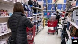 Shoppers shop at a retail store in Niles, Ill., Dec. 18, 2021. 