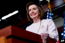 FILE - House Speaker Nancy Pelosi of California smiles during her weekly news conference on Capitol Hill in Washington, Oct. 21, 2021.