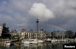 FILE - A rainbow appears on the Auckland skyline featuring Sky Tower in New Zealand, July 8, 2017.