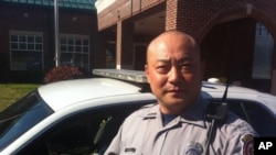 Pfc. Roy Choe of the Fairfax County Police Department, stands in front of Sully station where he was recently named officer of the year.