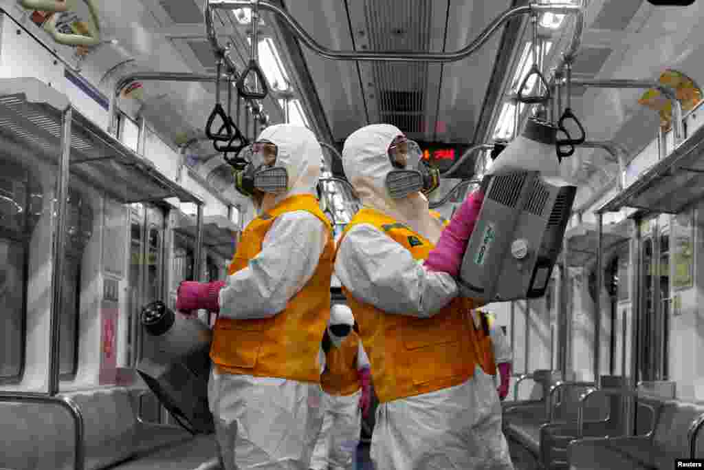 Employees from a disinfection service company sanitize a subway car depot amid coronavirus outbreak in Seoul, South Korea.