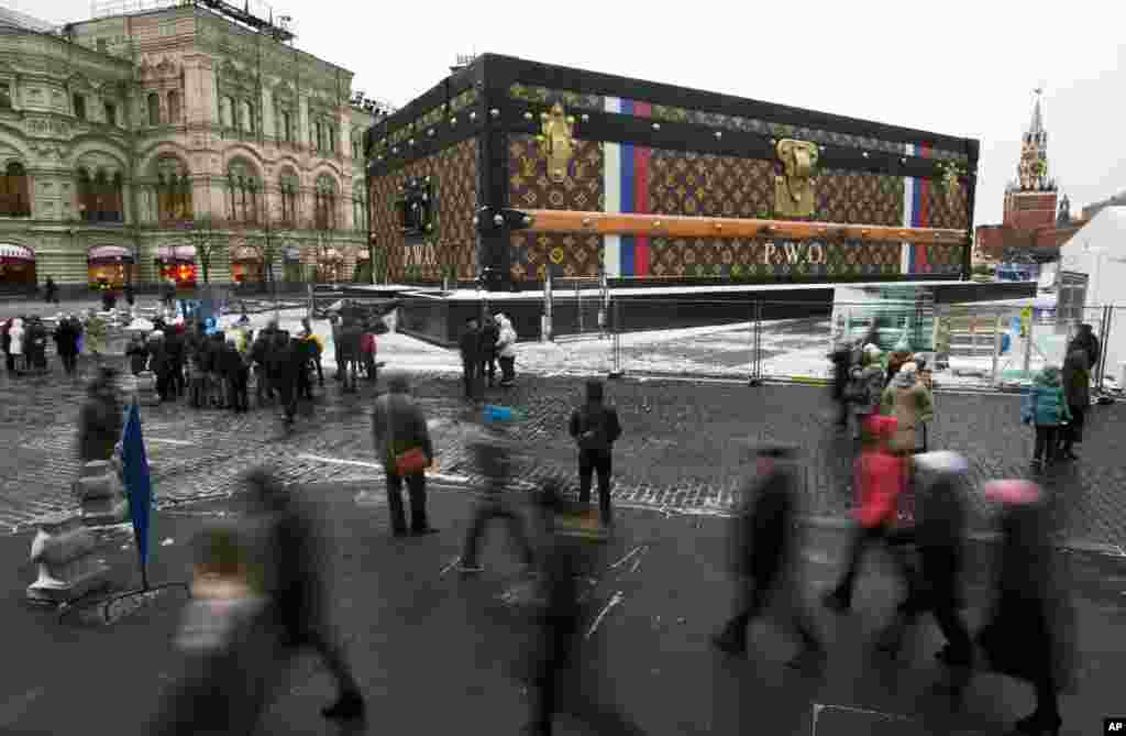 Tourists and visitors pass by a two-story Louis Vuitton suitcase erected at the Red Square in Moscow, Russia. Politicians didn&rsquo;t like it, the public didn&rsquo;t like it, so the gigantic Louis Vuitton suitcase is being booted out of Red Square. The GUM department store on Red Square, which is responsible for 30-feet (nine meters) high and 100-feet (30-meters) long construction, promised in a statement that it would be dismantled.