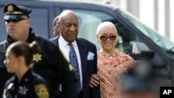 FILE - Bill Cosby arrives with his wife, Camille, right, for his sexual assault trial at the Montgomery County Courthouse in Norristown, Pennsylvania, April 24, 2018.