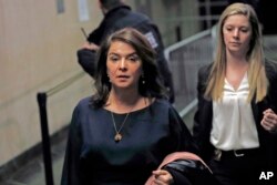 Actress Annabella Sciorra, left, leaves Manhattan Criminal Court after appearing at Harvey Weinstein's rape and sexual assault trial, Thursday, Jan. 23, 2020, in New York. (AP Photo/Kathy Willens)