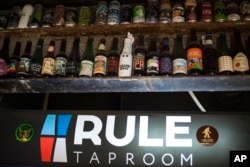 In this July 21, 2017 photo, bottles of various beer are displayed at the RULE Taproom pub in Moscow, Russia.