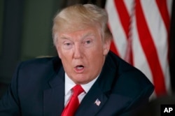 FILE - President Donald Trump speaks during a briefing at Trump National Golf Club in Bedminster, N.J., Aug. 8, 2017.