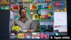 Hatem El-Gamasy works behind the counter at Lotus Deli in Queens, New York, where he sometimes stays until 2 a.m. or later. 