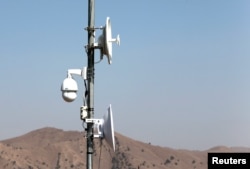 FILE - Electronic surveillance equipment is seen along the border fence, outside the Kitton outpost on the border with Afghanistan, in North Waziristan, Pakistan, Oct. 18, 2017.