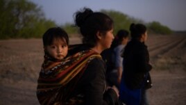 Mayra, a 17-year-old asylum-seeking mother from Guatemala, carries her 13-month-old son Marvin after they crossed the Rio Grande river into the United States from Mexico on a raft in Penitas, Texas, U.S., March 17, 2021. (REUTERS/Adrees Latif)
