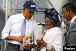 FILE - President Barack Obama speaks with a farmer participating in the Feed the Future program as he tours the Faffa Food factory in Addis Ababa, Ethiopia, July 28, 2015.