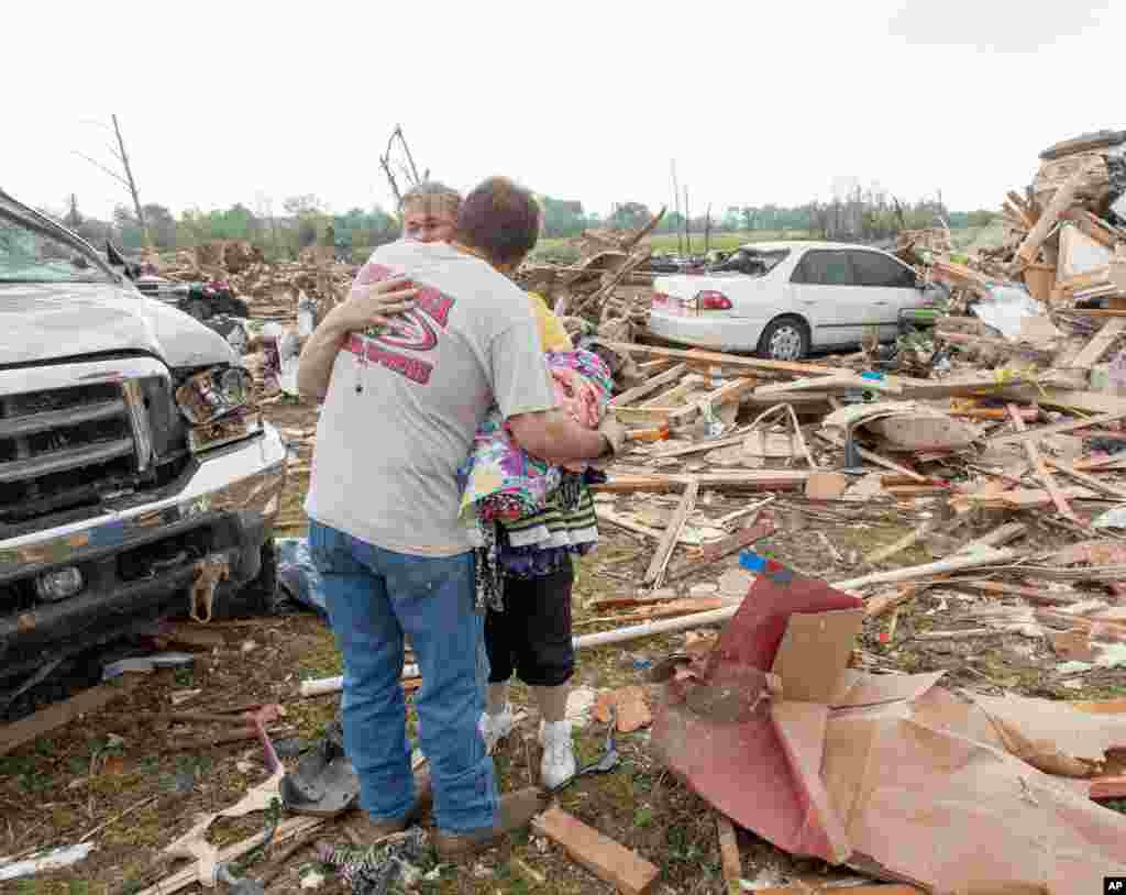Sherry Lee hugs her brother-in-law Andy Lee, April 28, 2013 after a tornado destroyed her home Sunday on Cemetery Street in Vilonia, Arkansas. 