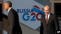 FILE - President Barack Obama, left, walks away after shaking hands with Russia's President Vladimir Putin at the G-20 summit in St. Petersburg, Russia on Sept. 5, 2013. 