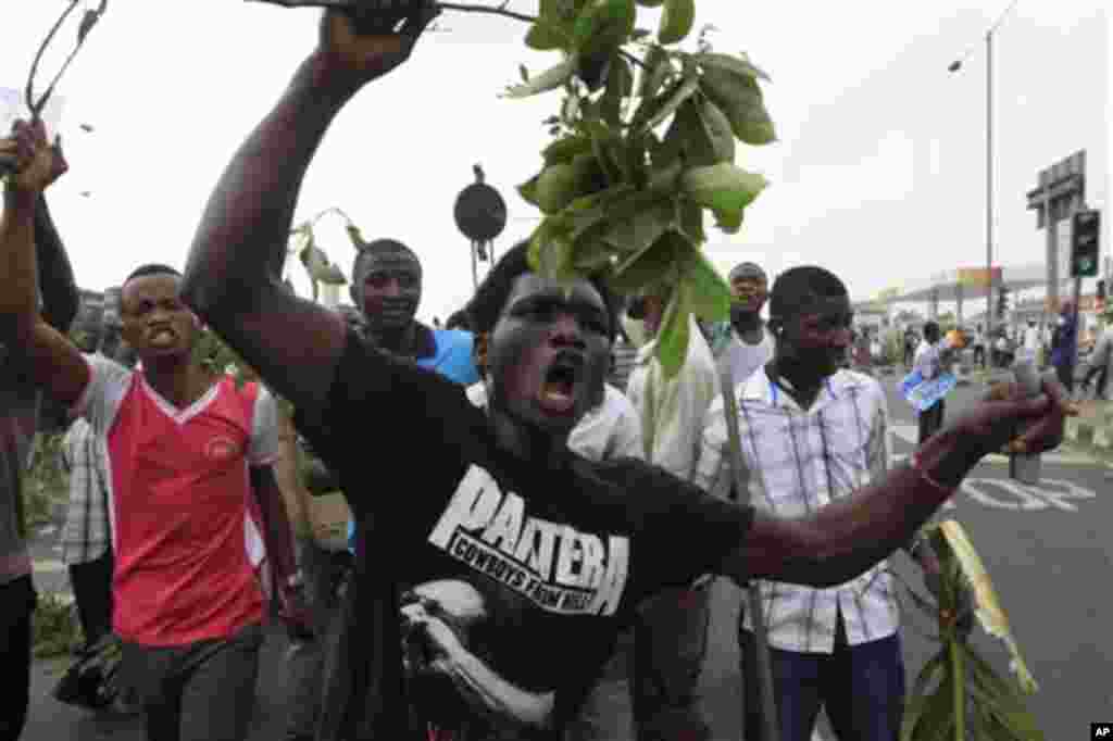 People protest on the second day of the ongoing strike following the removal of fuel subsidy by the government in Lagos, Nigeria, Tuesday, Jan. 10, 2012. As Nigeria's nationwide strike starts its second day, angry youths have erected a burning roadblock