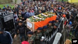 Indian army soldiers carry the body of their colleague Madan Lal Choudhary, who was killed in Saturday's militant attack on Indian army camp, during his funeral at village Bakrak, in Hiranagar, district Kathua, south of Jammu, India, Feb.12, 2018. 