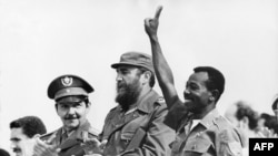 FILE - Ethiopian President Lieutenant Colonel Mengistu Haile Mariam (R) makes V sign as he stands with Fidel Castro (C) and Raul Castro (L) during an official visit in La Havana, Cuba, Apr. 25, 1975. Mengistu took part in the attempted coup against Haile Selassie in 1960 and in 1977 after a further coup he became undisputed ruler of his country. He was overthrown in 1991 by the Ethiopian People's Democratic Front. 