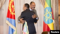 Ethiopian Prime Minister Abiy Ahmed and Eritrean President Isaias Afwerki embrace at the declaration signing in Asmara, Eritrea, July 9, 2018, in this photo obtained from social media. (Ghideon Musa Aron Visafric/via Reuters)