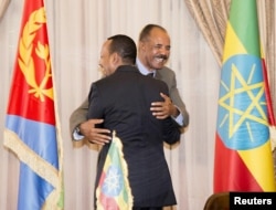 FILE - Ethiopian Prime Minister Abiy Ahmed and Eritrean President Isaias Afwerki embrace at a peace declaration signing in Asmara, Eritrea, July 9, 2018, in this photo obtained from social media. (Ghideon Musa Aron Visafric/via Reuters)