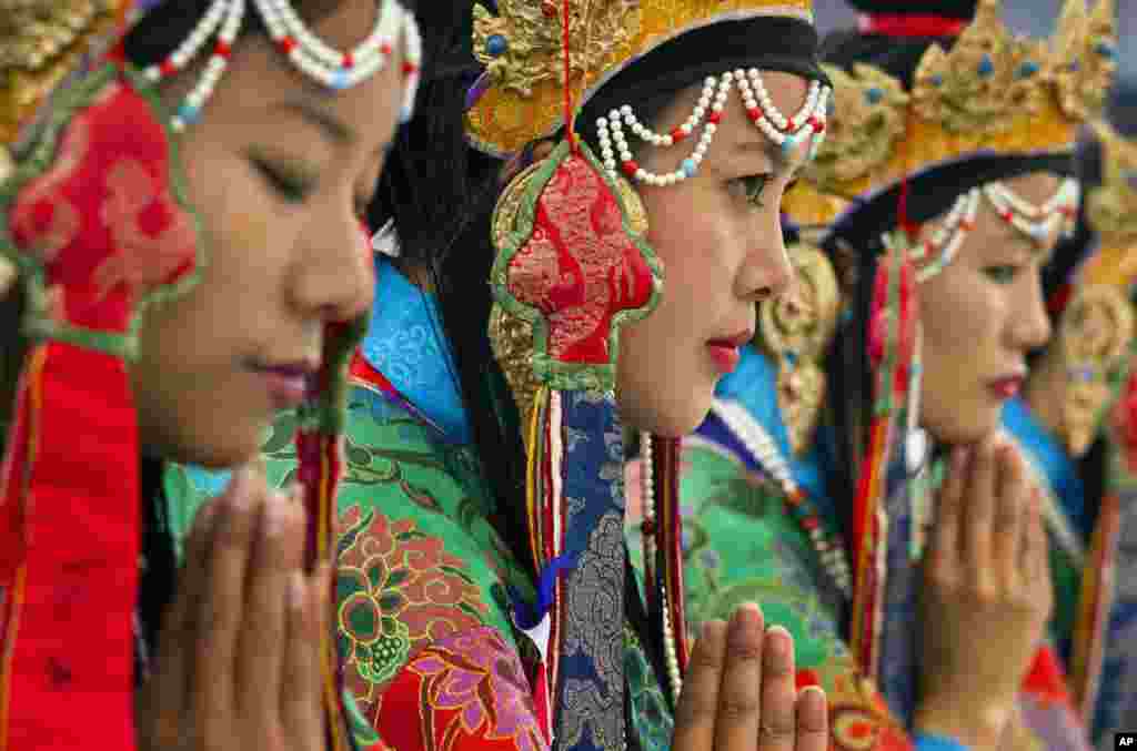 Tibetan artists in traditional costumes perform opera at the Tibetan Institute of Performing Arts in Dharamsala, India.