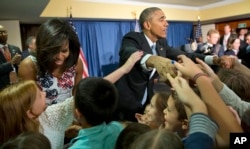 President Barack Obama and first lady Michelle Obama greet children and families of U.S. embassy personnel during an event at the Melia Habana Hotel in Havana, Cuba, March 20, 2016.