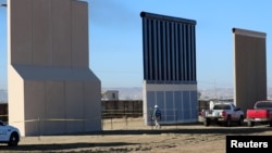 FILE - Three of U.S. President Donald Trump's eight border wall prototypes are shown near completion along U.S.- Mexico border in San Diego, California, Oct. 23, 2017. 