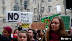 Immigration activists rally against the Trump administration's revised ban outside of the U.S. Customs and Border Protection headquarters in Washington, March 7, 2017.