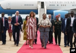 First lady Melania Trump walks with Ghana's first lady Rebecca Akufo-Addo as she arrives at Kotoka International Airport in Accra, Ghana, Oct. 2, 2018.