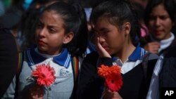 Mexicans students stand together as they form a symbolic human wall along the Rio Grande, which marks part of the border between Mexico and the U.S. in Ciudad Juarez, Feb. 17, 2017. More than a thousand people lined the Mexican bank of the Rio Grande in Ciudad Juarez Friday, holding hands and carrying flowers. 