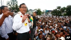 Head of opposition Cambodia National Rescue Party Sam Rainsy, second from left, gives a speech during a rally of their supporters after the July 28 polls, in Phnom Penh, Cambodia, Tuesday, Aug. 6, 2013. 