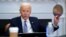 FILE - President Joe Biden holds up a silicon wafer as he participates virtually in the CEO Summit on Semiconductor and Supply Chain Resilience at the White House, April 12, 2021, in Washington. On Jan. 21, 2022, he touted a $20 billion investment by Inte