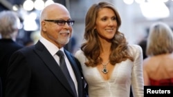 FILE - Singer Celine Dion and her husband Rene Angelil arrive at the 83rd Academy Awards at the 83rd Academy Awards in Hollywood, California, Feb. 27, 2011.