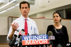 FILE - Then-New York mayoral candidate Anthony Weiner speaks during a news conference alongside his wife Huma Abedin in New York.