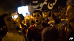 Supporters of Egypt's ousted President Mohammed Morsi chants slogans against the Egyptian Army after "Iftar" during a protest near Cairo University in Giza, Egypt, Aug. 4, 2013.